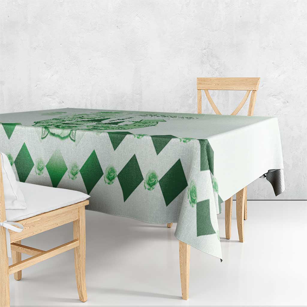 Green diamond-pattern tablecloth draped over dining table edge