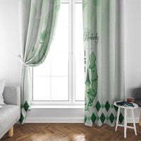 Green and white window curtain with horse graphic, gathered at the side near a window.