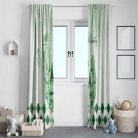 Green window curtain set with horse and diamond pattern, hanging over a white door.