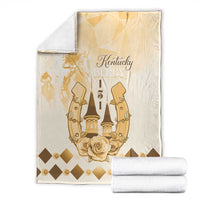Beige blanket folded for display, featuring gold Kentucky Derby emblem and rose wreath