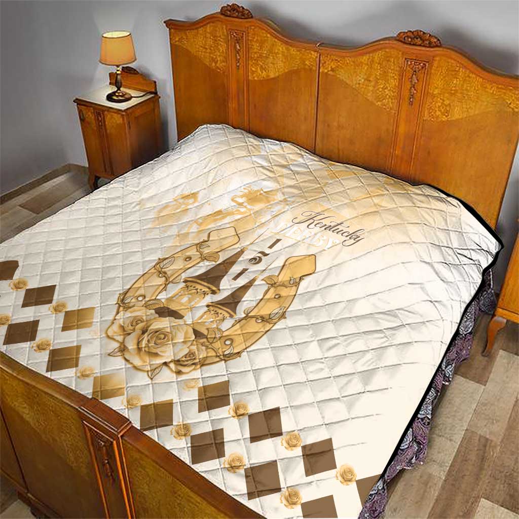 Quilt on bed featuring diamond quilting and gold Kentucky horse emblem, beige accent border