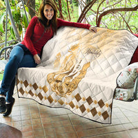 Quilt draped on couch with diamond quilting, gold Kentucky horse emblem, and beige border