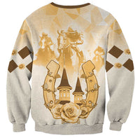 Beige crewneck sweatshirt with gold horse-rider crest and roses graphic, long sleeves.