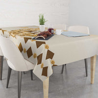 Beige tablecloth with brown diamond stripes and gold rose decorations