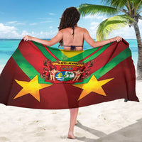 Red and green diagonal striped sarong with yellow stars and crest, draped for coverage