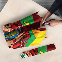 Folded umbrella fabric laid flat showing red, green, yellow geometric star print