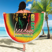 Person holding round beach blanket with rainbow lion graphic, 1865 Freedom Juneteenth text, fringe