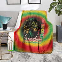 Rainbow tie-dye blanket showing lion head, “1 8 6 5,” and “freedom JUNETEENTH”