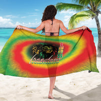 Rainbow tie-dye sarong with lion graphic and '1865' text, draped wide.