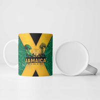 Green ceramic Jamaica mug with black and gold X graphic, side handle visible
