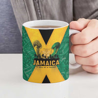 Green ceramic Jamaica mug held in hand; gold and black X graphic on front