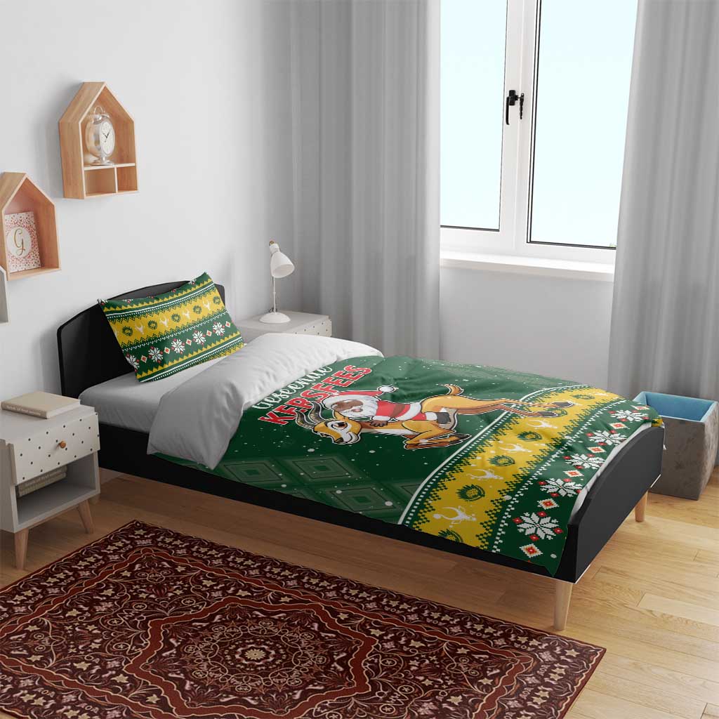 Green Christmas bedding set on bed with Santa riding springbok design and border print