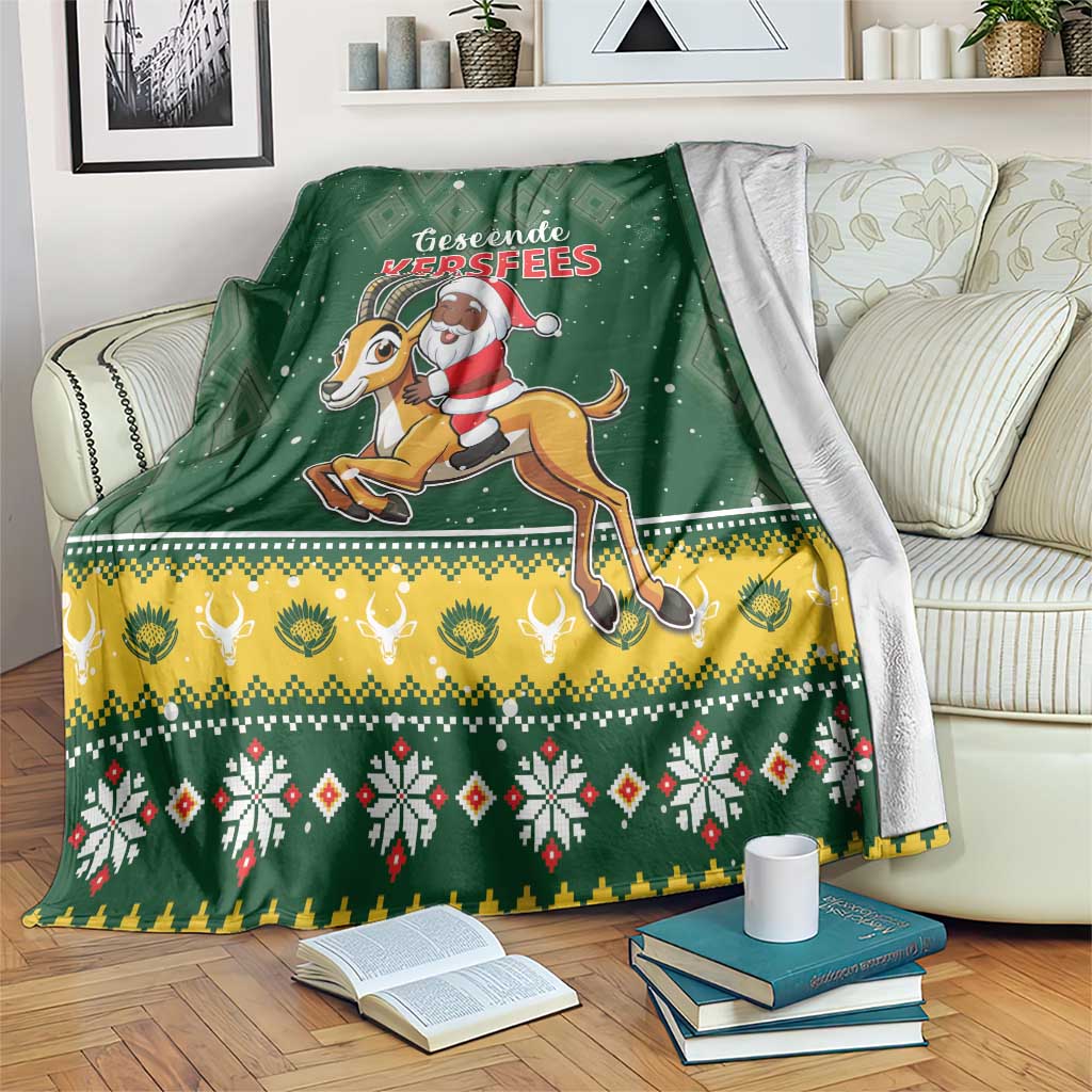 Green Christmas throw blanket with Santa riding a springbok and festive border pattern