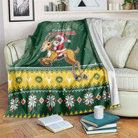 Green Christmas throw blanket with Santa riding a springbok and festive border pattern