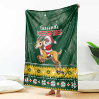 Green blanket with Santa riding a springbok, diamond backdrop and holiday stripe border