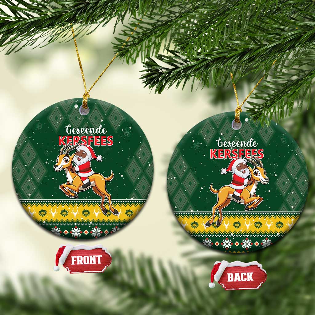 Green round ceramic Christmas ornament set with Santa riding springbok graphic, front and back.