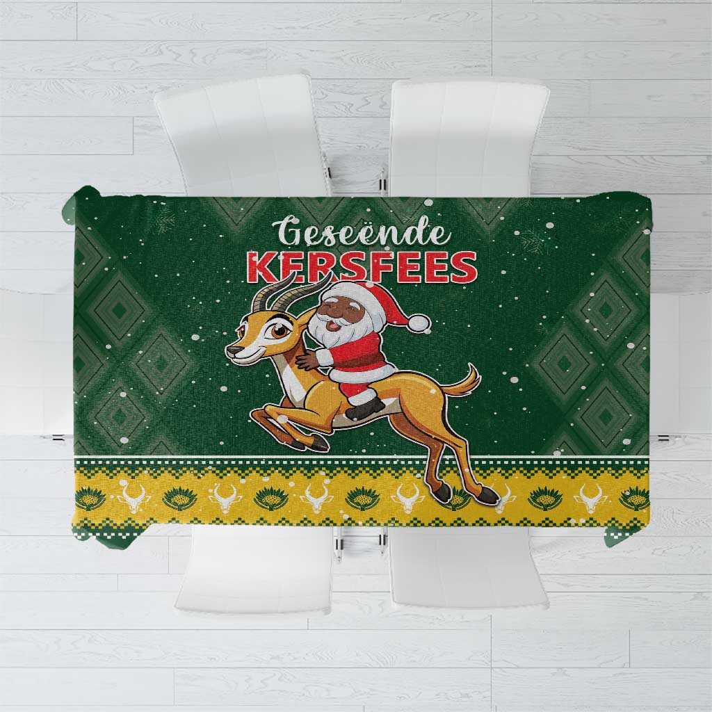 Green Christmas tablecloth with Santa riding a springbok and diamond border pattern