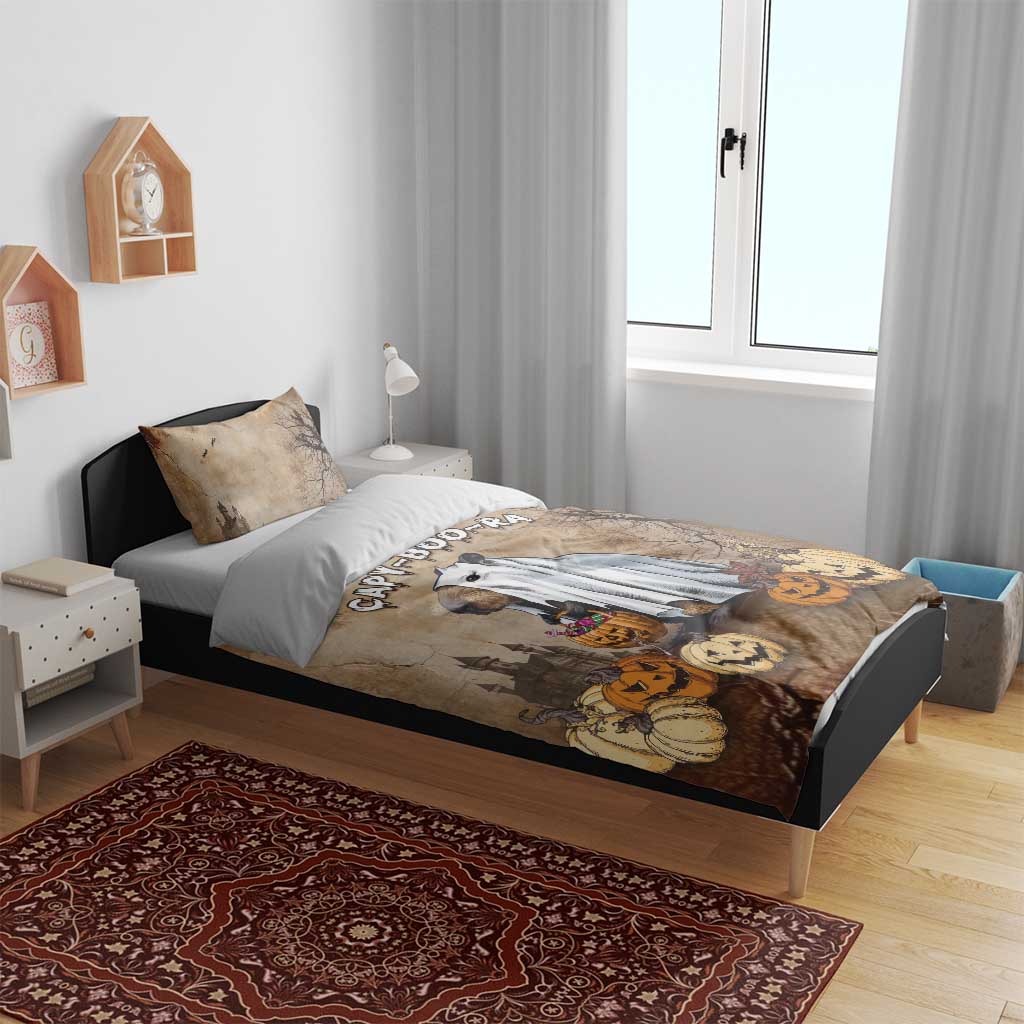 Halloween bedding set on bed: beige-brown duvet featuring capybara ghost, with two pillowcases
