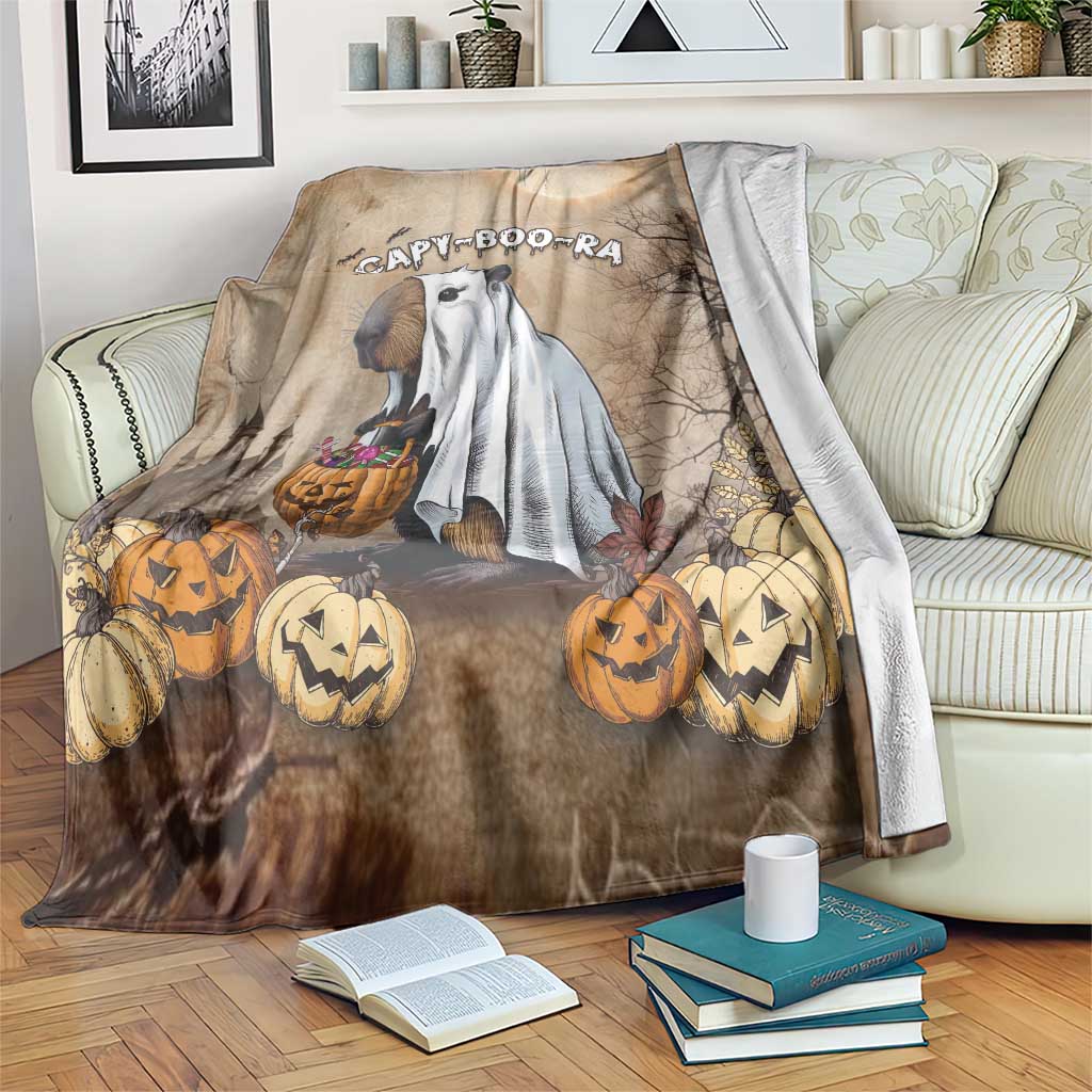 Beige Halloween throw blanket with capybara ghost and jack-o'-lantern pumpkins