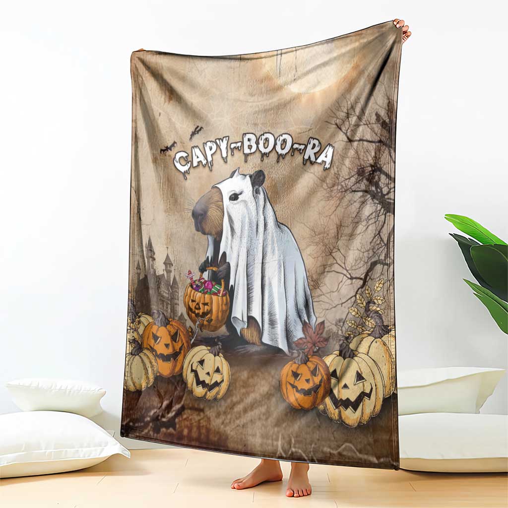Halloween blanket with capybara ghost on beige background, draped showing pumpkin border