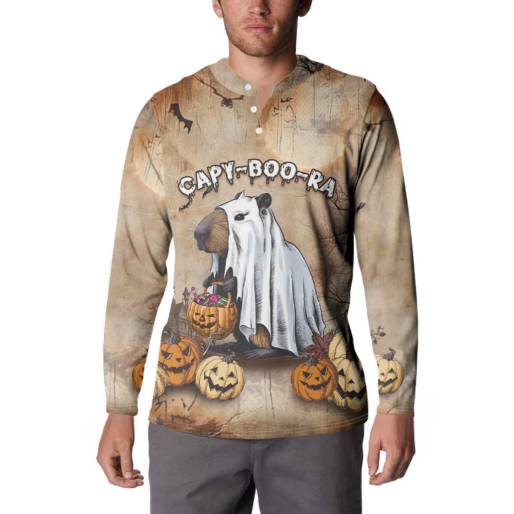 Beige long-sleeve button sweatshirt worn by model, capybara and jack-o’-lantern print.