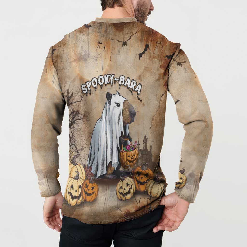 Beige long-sleeve button sweatshirt worn by model, back capybara with pumpkins graphic.