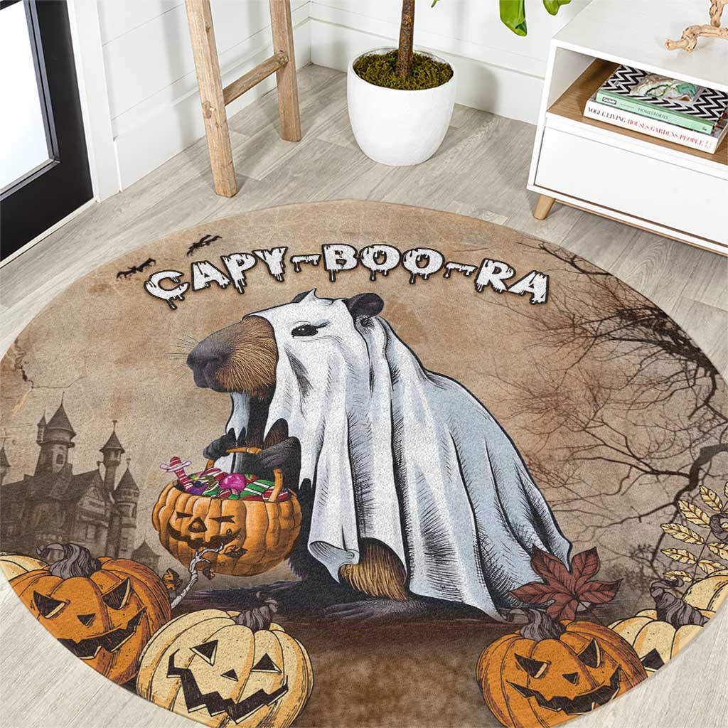 Beige round Halloween rug with capybara, pumpkins, and spooky castle graphic