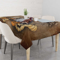 Brown Halloween tablecloth draped on table with capybara, pumpkins, and spooky bats