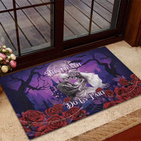 Purple Halloween skeleton couple doormat framed by red roses near an entryway