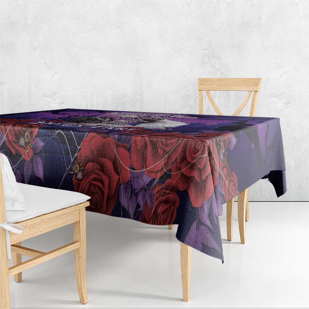 Purple tablecloth draped over dining table with dark roses and spiderweb pattern
