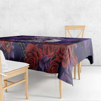 Purple tablecloth draped over dining table with dark roses and spiderweb pattern