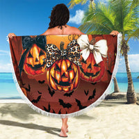 Orange round Halloween beach blanket with fringe, pumpkins and "Spooky season" graphic