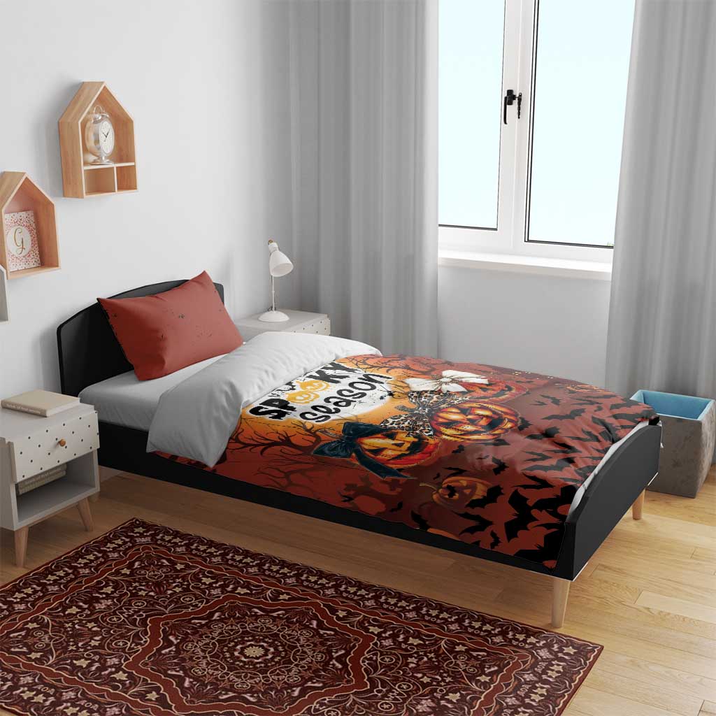 Orange Halloween bedding set with duvet and two pillowcases on a bed in a bedroom
