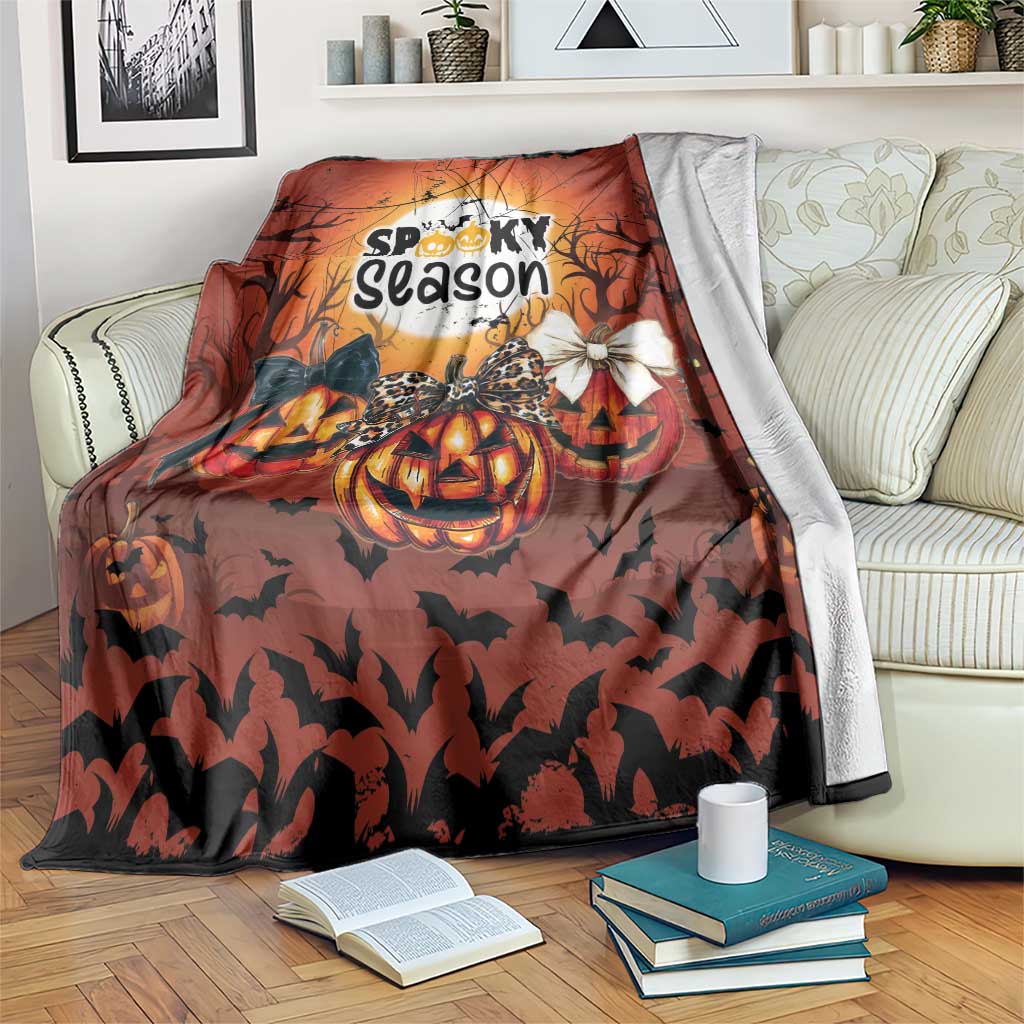 Orange Halloween blanket with “Spooky season” print, pumpkins, bats, and ghost graphic