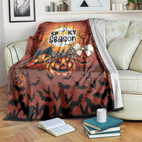 Orange Halloween blanket with “Spooky season” print, pumpkins, bats, and ghost graphic