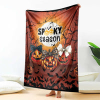 Orange Halloween throw blanket featuring “Spooky season” text with jack-o’-lanterns and bats
