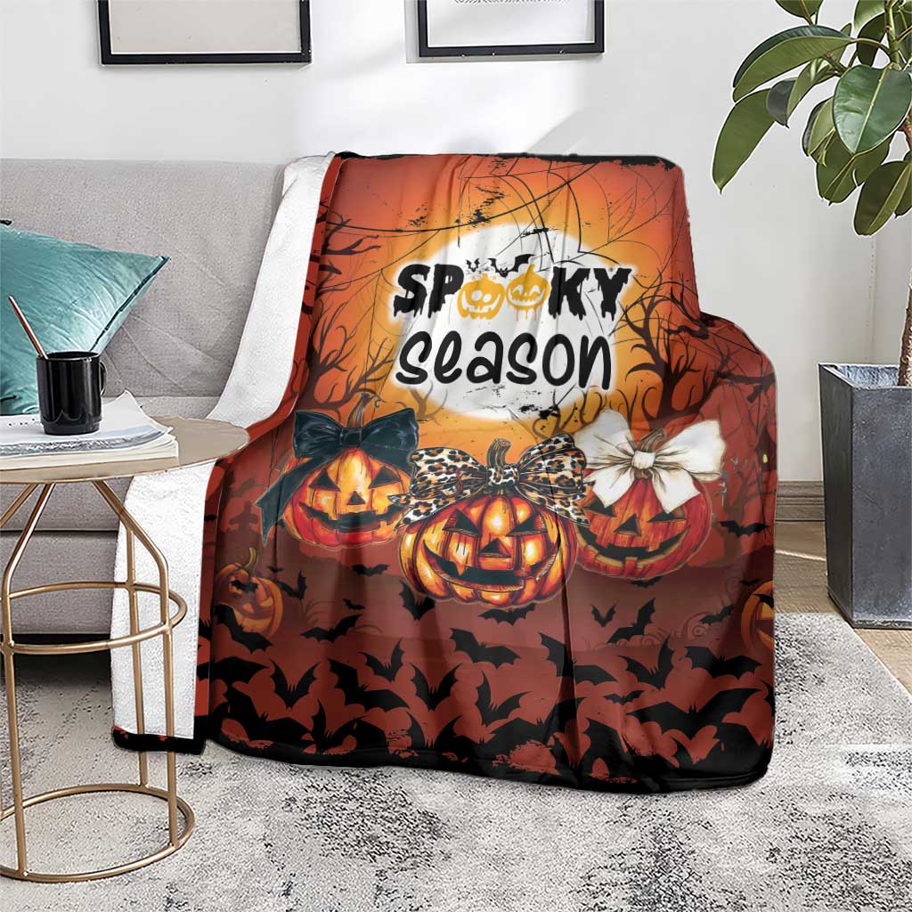 Orange Halloween blanket with “Spooky season” artwork, jack-o’-lantern pumpkins and bats