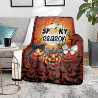 Orange Halloween blanket with “Spooky season” artwork, jack-o’-lantern pumpkins and bats