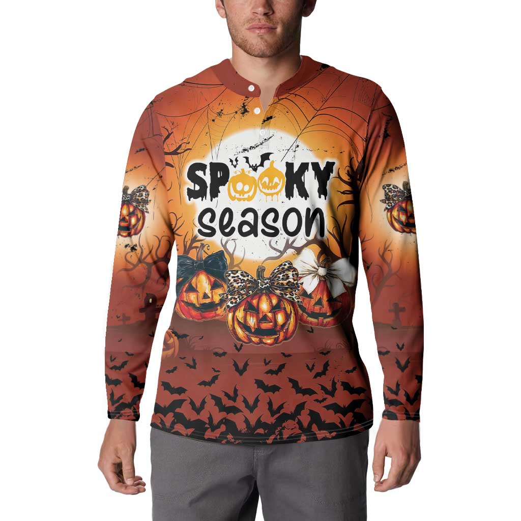 Orange Halloween button sweatshirt worn by a man, front graphic with pumpkins and bats