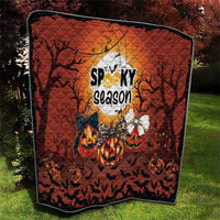 Halloween wall-hanging quilt with orange jack-o-lanterns, bats, and “spooky season” text
