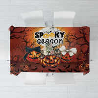 Orange and dark brown Halloween tablecloth with “Spooky season” text and pumpkins