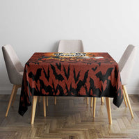 Square Halloween tablecloth in dark orange with bat silhouettes across the surface