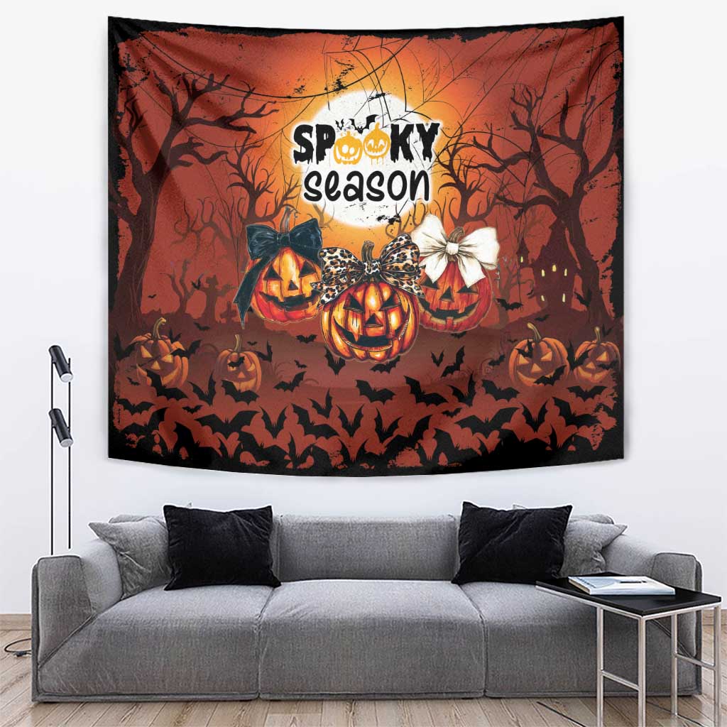 Orange Halloween tapestry with jack-o’-lantern pumpkins, bat silhouettes, and “Spooky season” text.