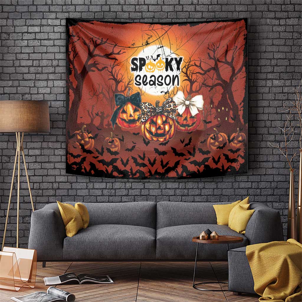 Orange Halloween wall tapestry with jack-o’-lantern pumpkins, bats, and centered “Spooky season” lettering.