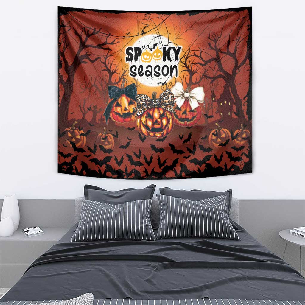 Orange Halloween tapestry featuring “Spooky season,” pumpkins, bats, and tree silhouettes.