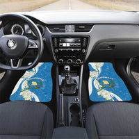 Blue car mats featuring Guatemala crest and white flowers on front footwells