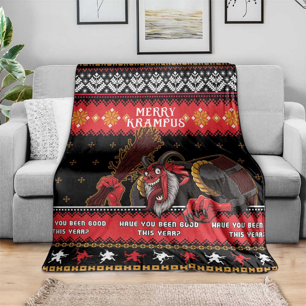 Christmas Krampus throw blanket draped over gray sofa, red and black festive pattern
