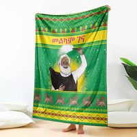 Green Christmas blanket with saint portrait, decorative stripes, and running animal border