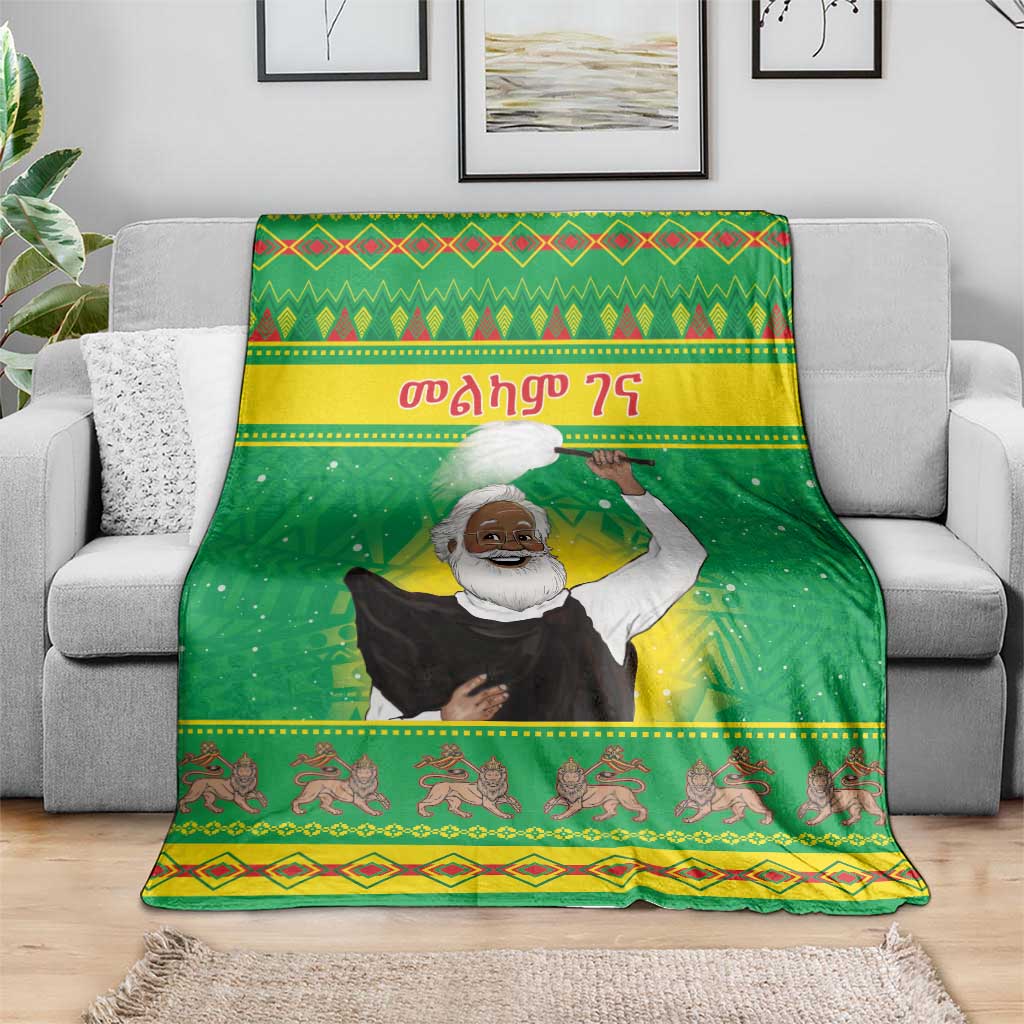 Green Christmas blanket featuring a saint figure, colorful bands, and patterned animal row