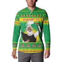 Green button-up sweatshirt on model with front graphic, long sleeves, collared neckline